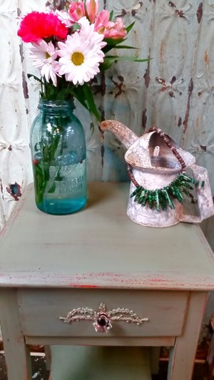 A small table that I painted. I also created the embellishment that is on t...
