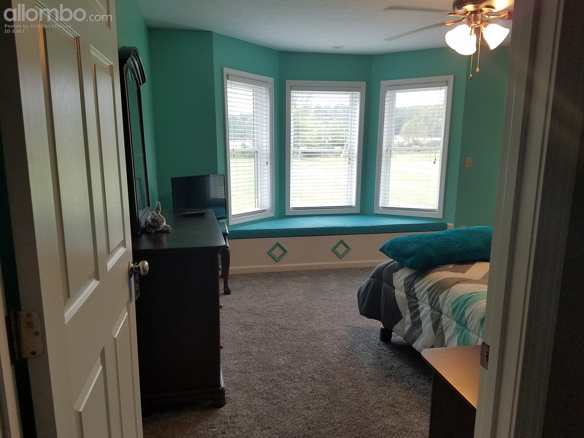 baby girls room with window seat inside