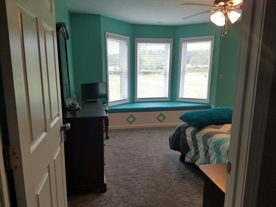 baby girls room with window seat inside