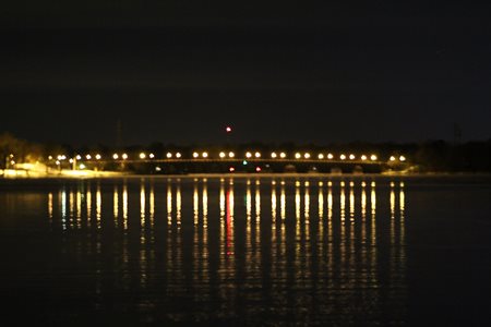 Bridge across a narrow spot at a local lake at night