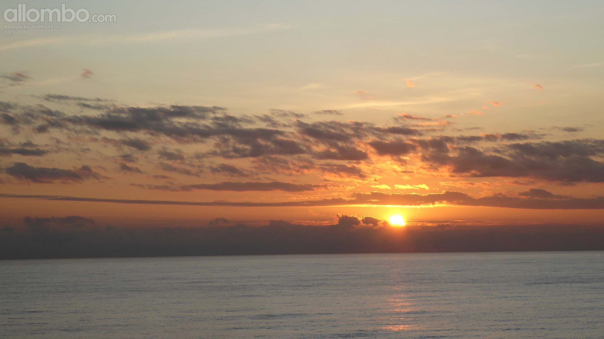 Sunrise over a calm Timor Strait.