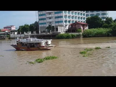 Towing rice barges on the Chao Praya River in Ayutthaya, Thailand