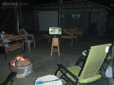 Enjoying Micks Bar Stool TV stand outside by the fire Pit.